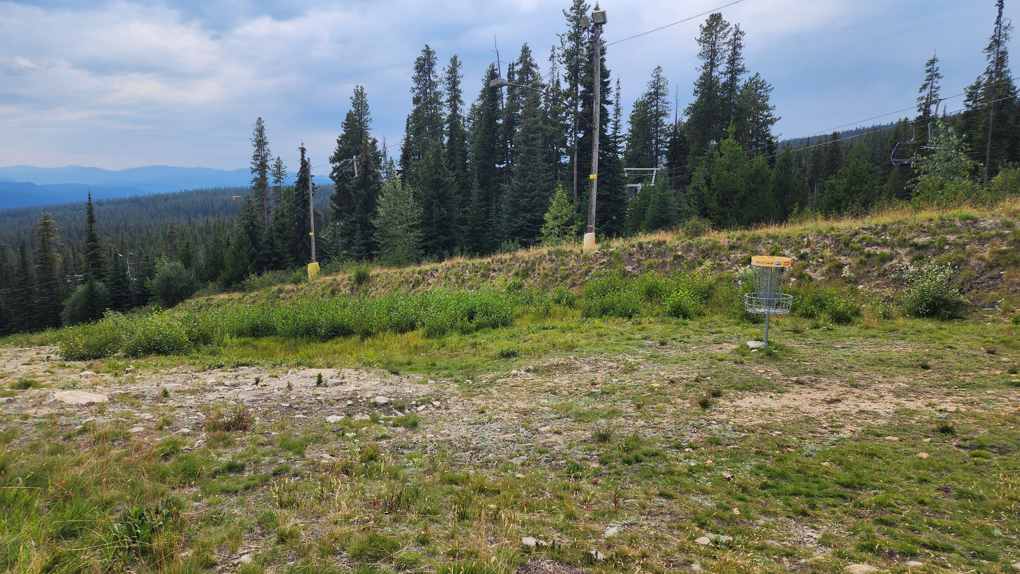 Mountain landscape with a disc golf basket silhouette